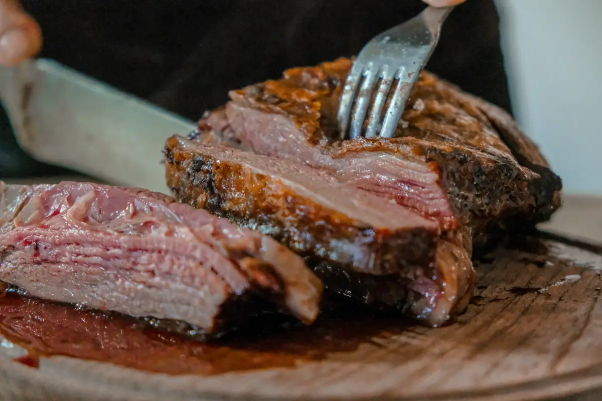 Steak being sliced on a board