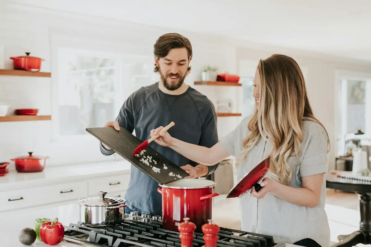 Two people cooking together in a home kitchen