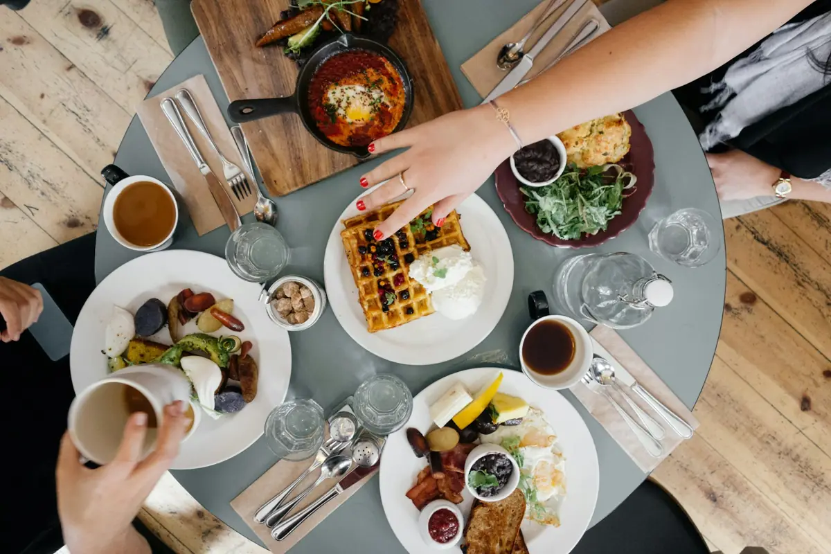 Shared dishes on a dinner table seen from above